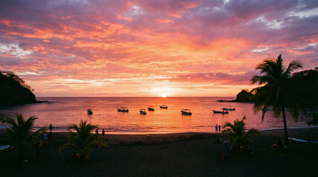 A beautiful sunset over the bay in Playas del Coco, with fishing boats silhouetted against the colorful sky.