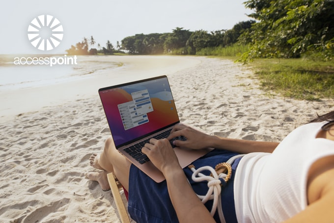 working on a laptop sitting on the beach in Costa Rica