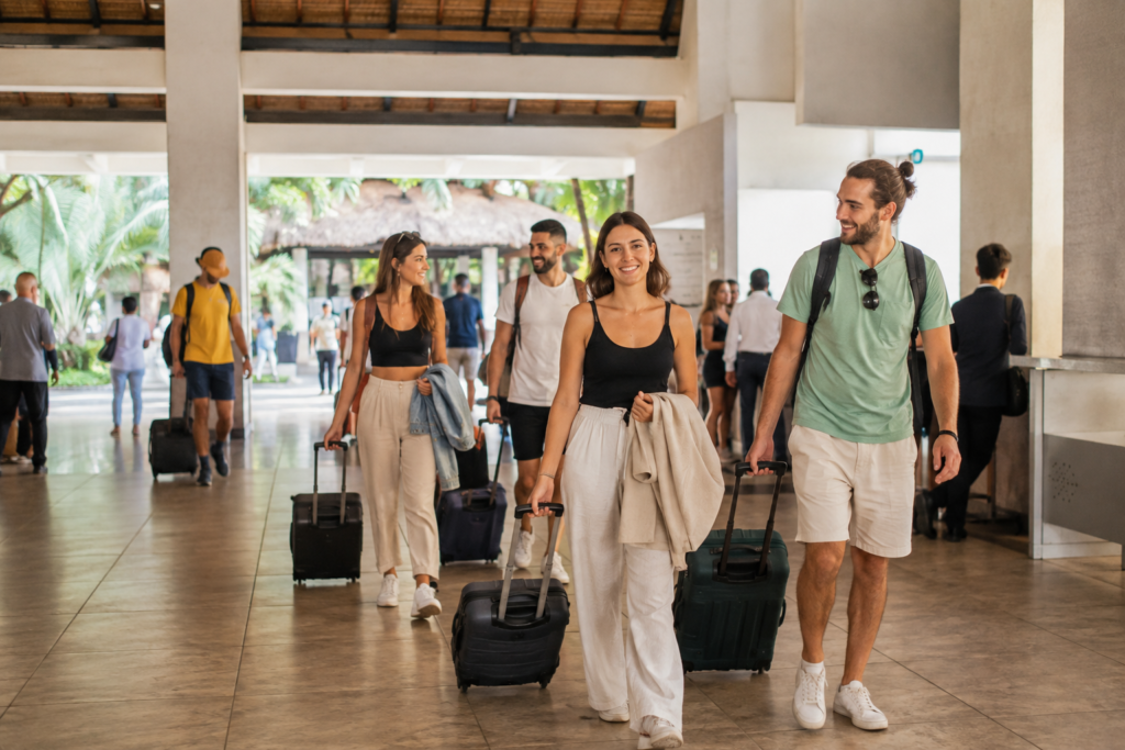 Travelers with luggage in an airport arrivals area.