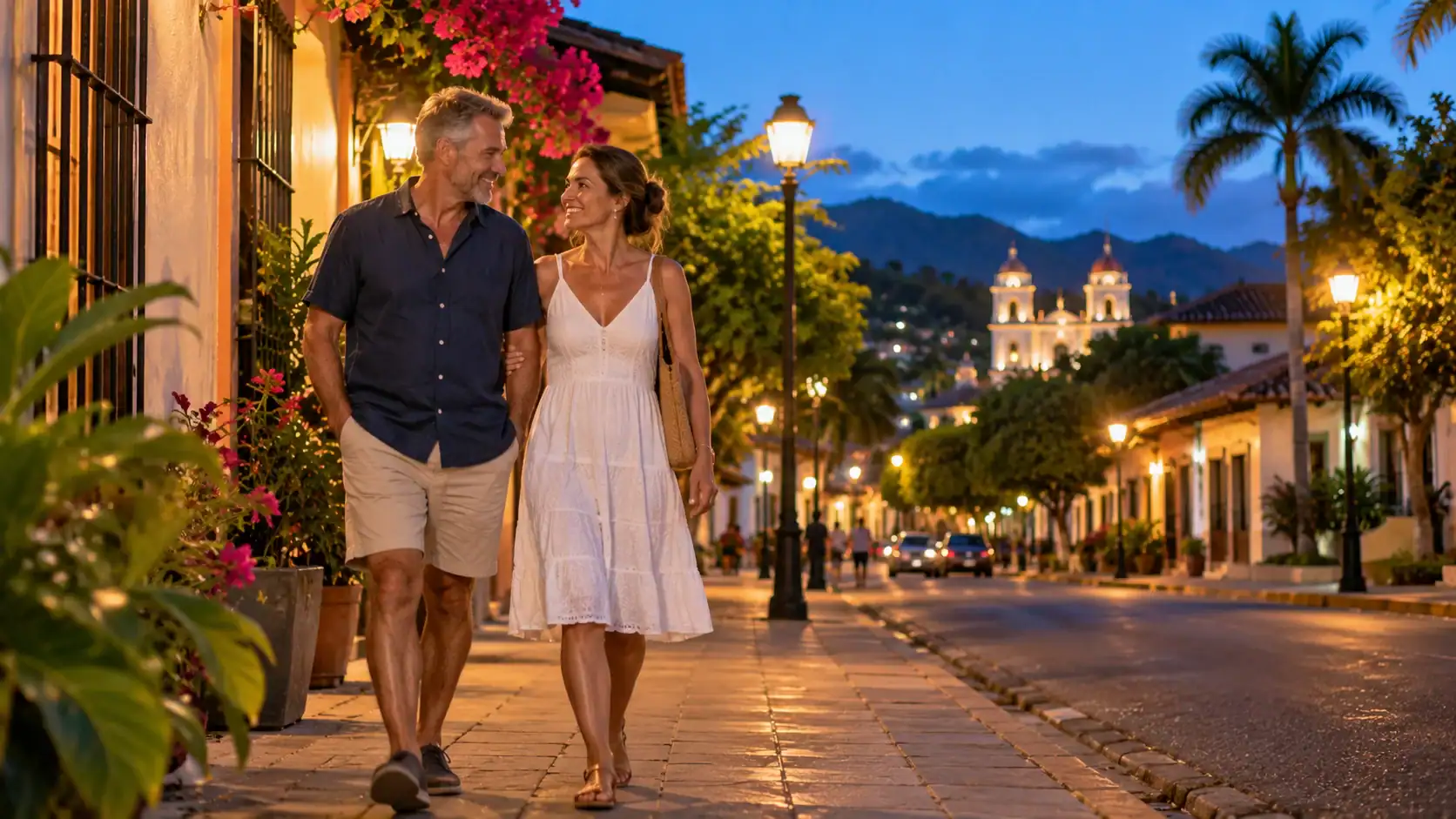 A couple walking home on a well-lit street in a Costa Rican town in the evening