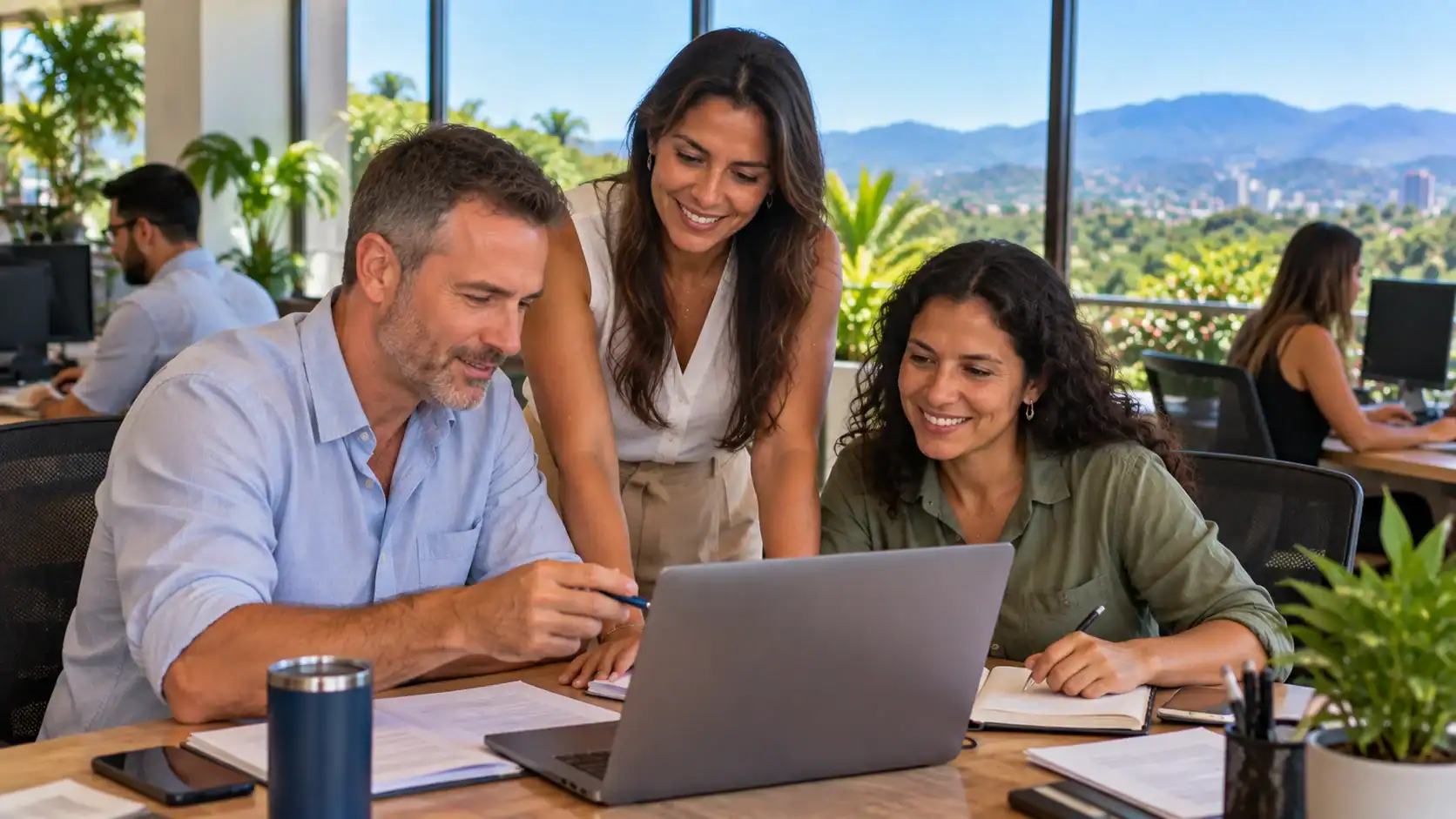 A foreign professional working alongside Costa Rican colleagues in a modern office
