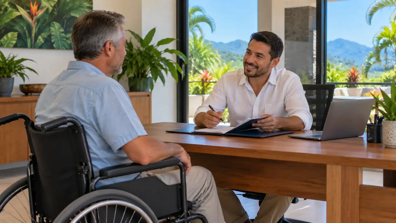 A man in a wheelchair meeting an adviser in an accessible office
