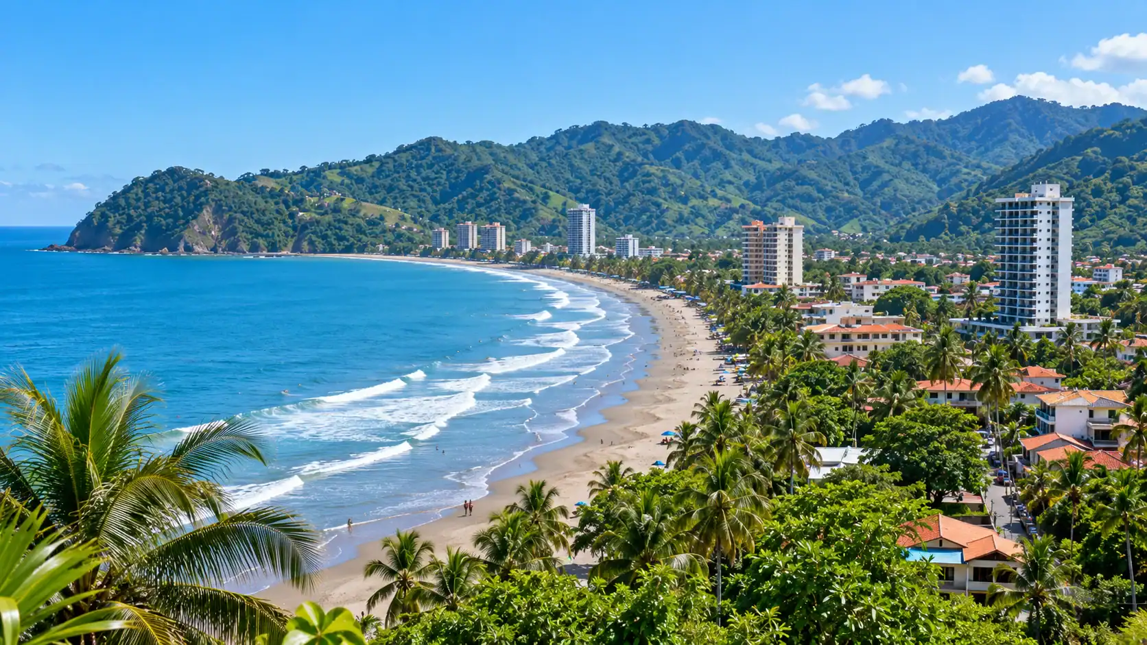 A view of Jacó beach town in Costa Rica with the ocean and green hills