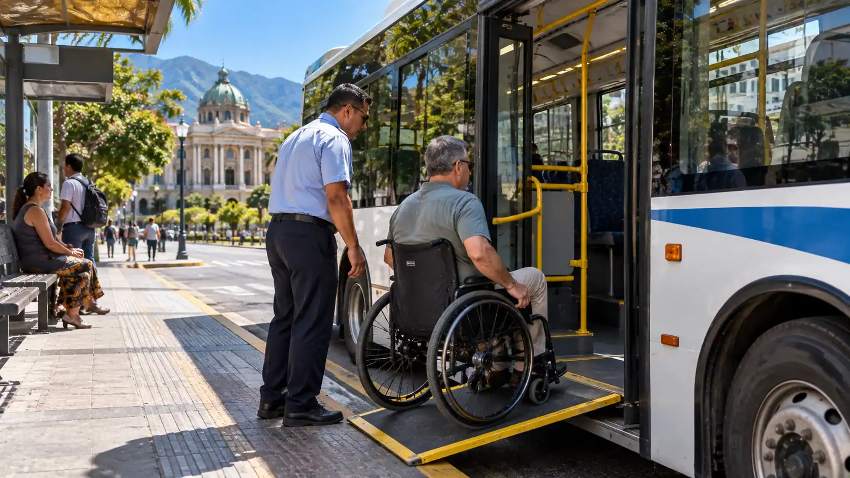 A wheelchair user boarding a low-floor bus with a ramp in San José