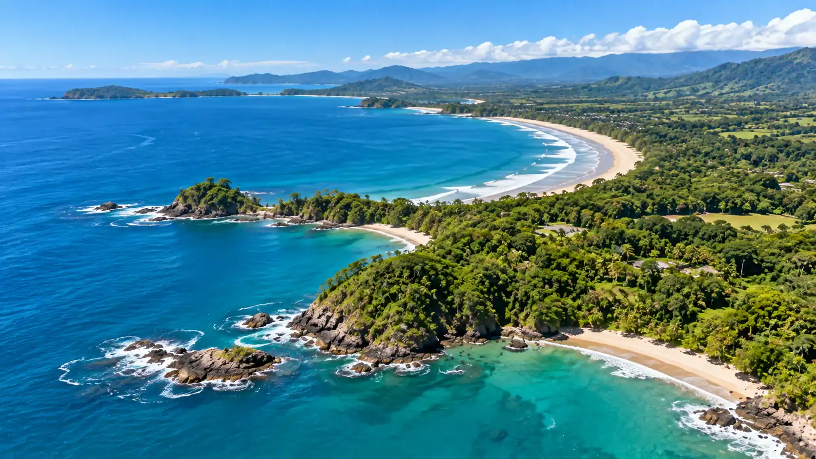 An aerial view of a long Pacific coastline with beaches and headlands in Costa Rica