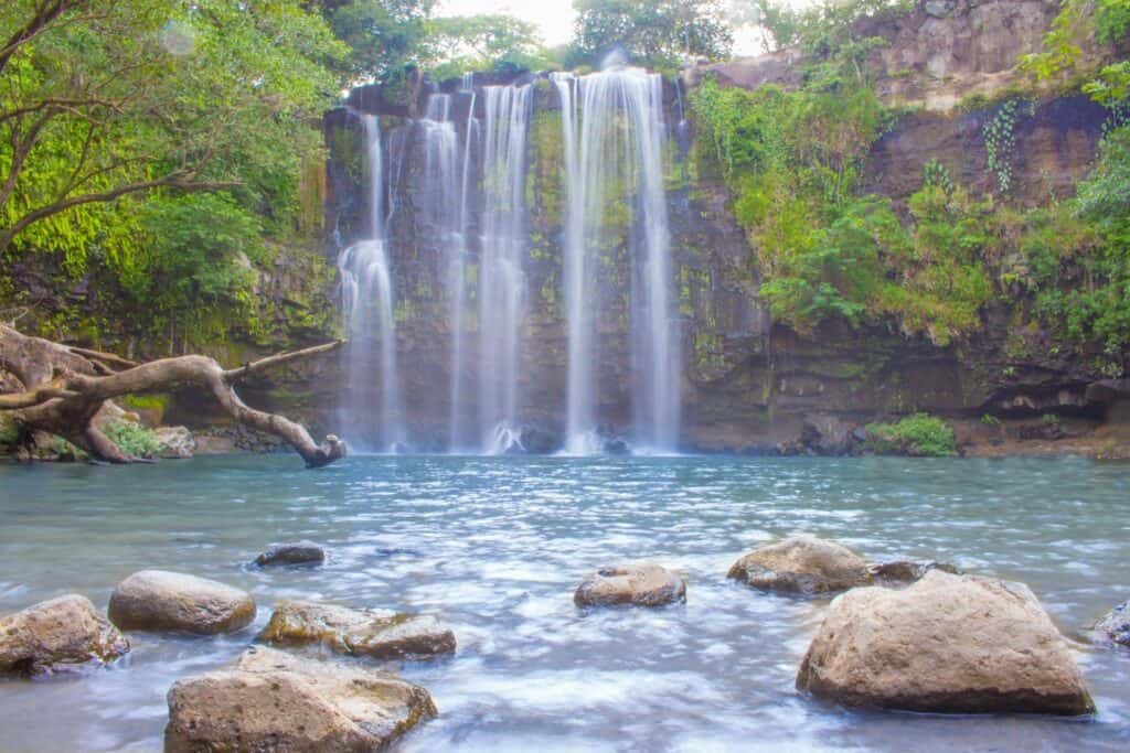 Llanos de Cortés waterfall, a wide curtain of water over a pool near Bagaces, Guanacaste