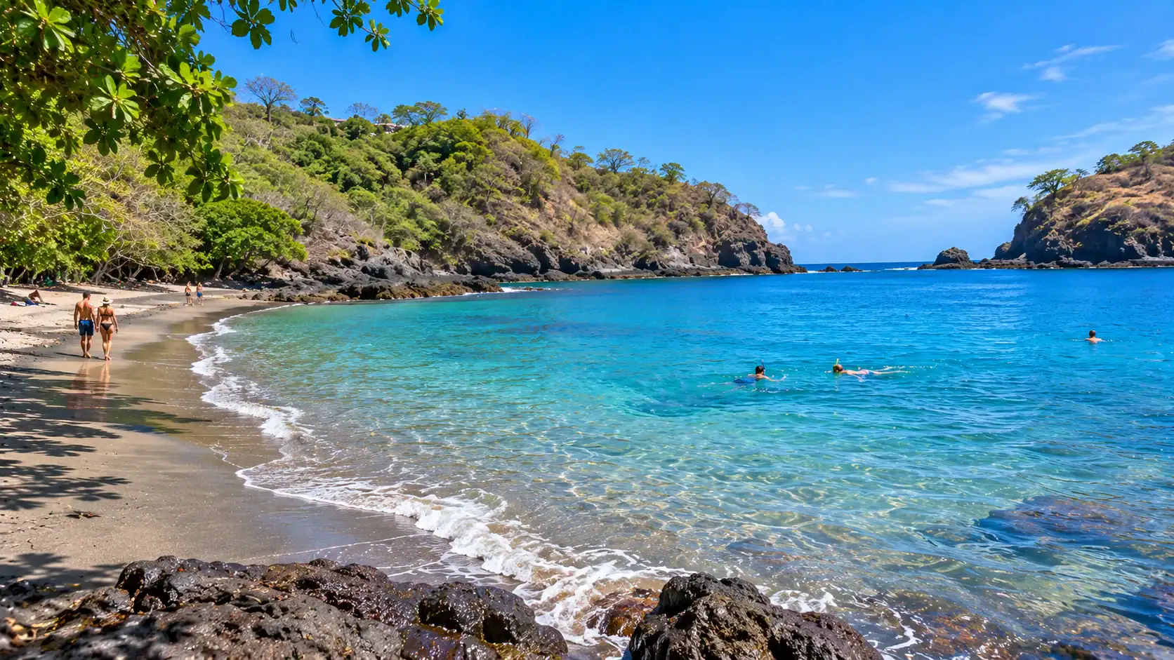 Snorkelers in the clear water of the sheltered cove at Playa Ocotal, Guanacaste