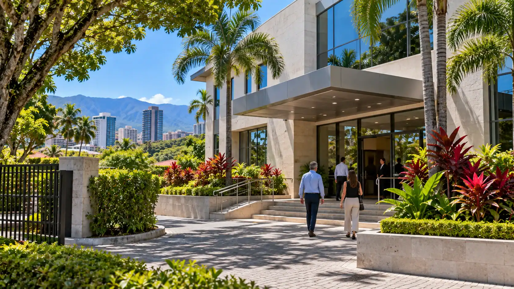The exterior of a modern embassy building with gardens in San José, no flags or signs